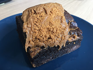 A brownie with biscoff spread and crumbs on top.