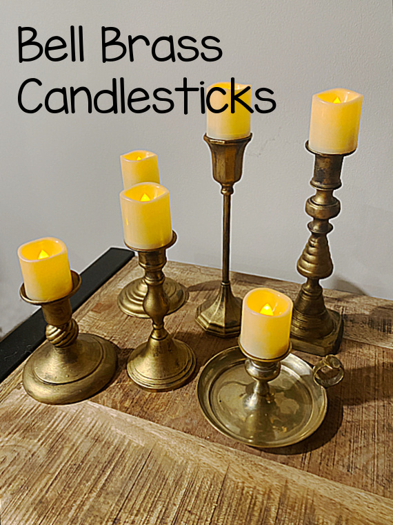 brass candlesticks with votives and overlay
