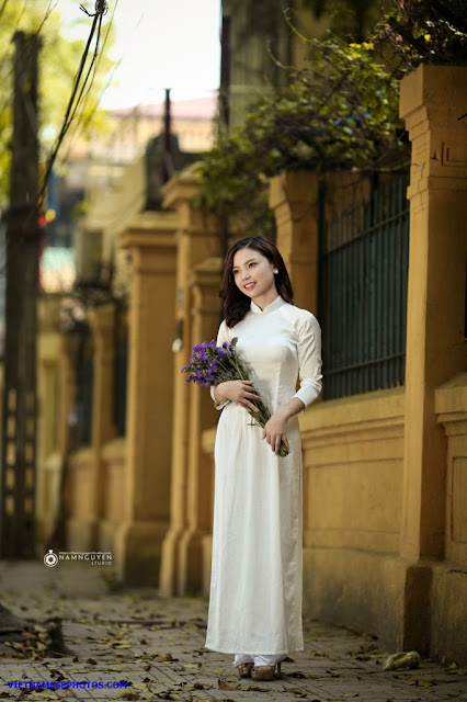 Vietnamese teen girl walking on the street with white ao dai 5