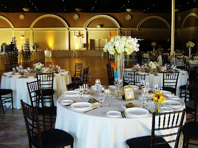 The low centerpieces with gold framed table numbers