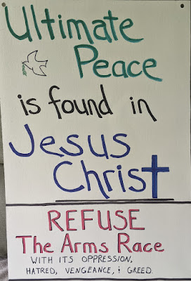 Homemade poster. Text: Ultimate Peace is found in Jesus Christ. Refuse the Arms Race with its oppression, hatred, vengeance & greed.. Small image of dove with olive branch