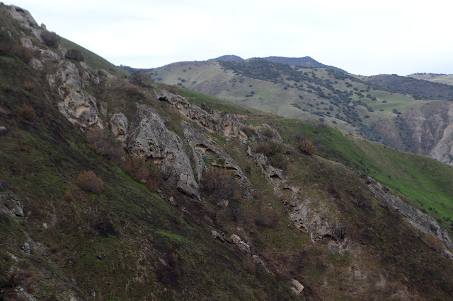 little, shallow holes in an otherwise vertical surface of sandstone