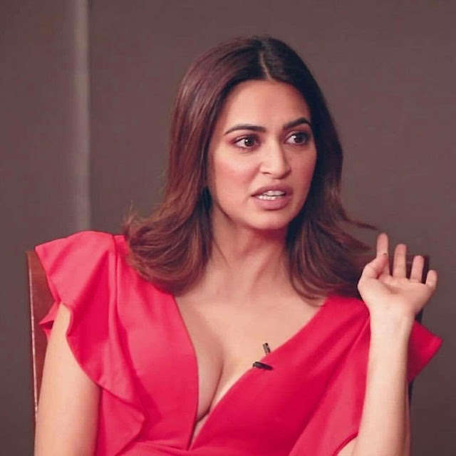 Kriti Kharbanda looking stunning in a red balloon-sleeved dress, embodying timeless elegance and sophistication.