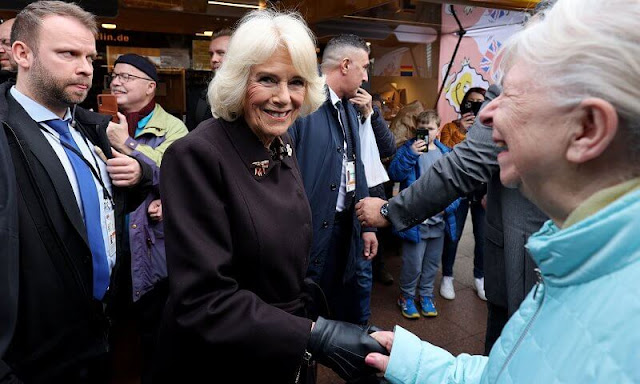 Queen Camilla and First Lady Elke Büdenbender visited the Komishe Oper in Berlin. Green blazer and brown wool coat