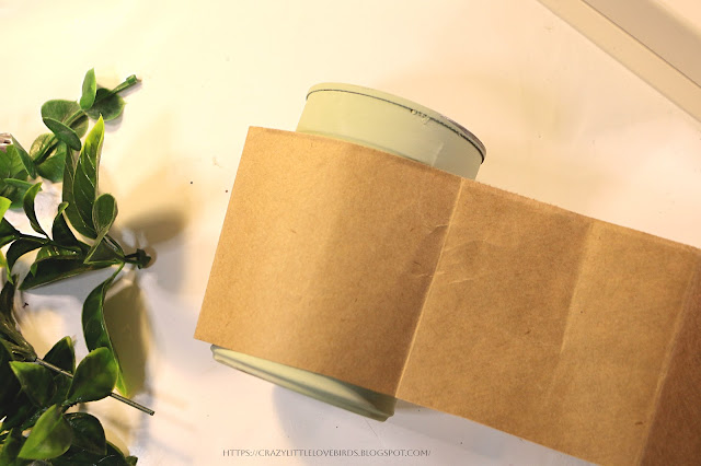 Metal can wrapped with brown paper