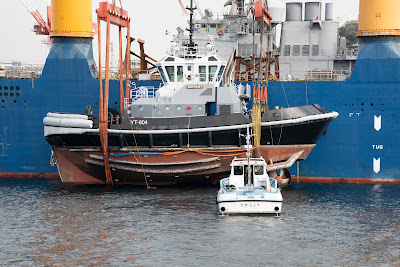 The Military Sealift Command Heavy Lift Vessel Ocean Jazz dropping the Valiant class harbor tug YT804 Defiant in water near Fleet Activities Yokosuka Japan on the 9th of December 2019