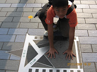 joel hands on jet li's handprints in hong kong