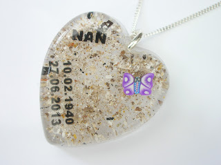 Heart shaped resin pendant containing ashes, purple butterfly and text