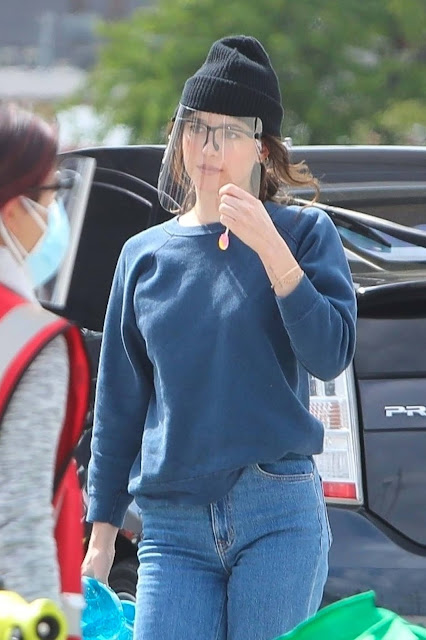Dakota Johnson - enjoys a lollypop on the set of 'Am I Ok?' while filming a car scene