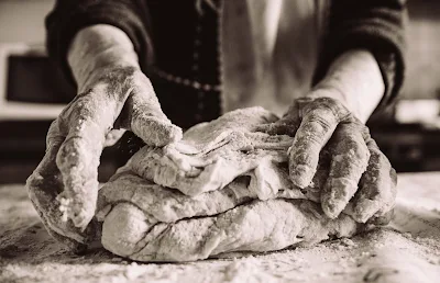 Mani di una nonna che impasta un lievitato, foto in bianco e nero ,Puglia