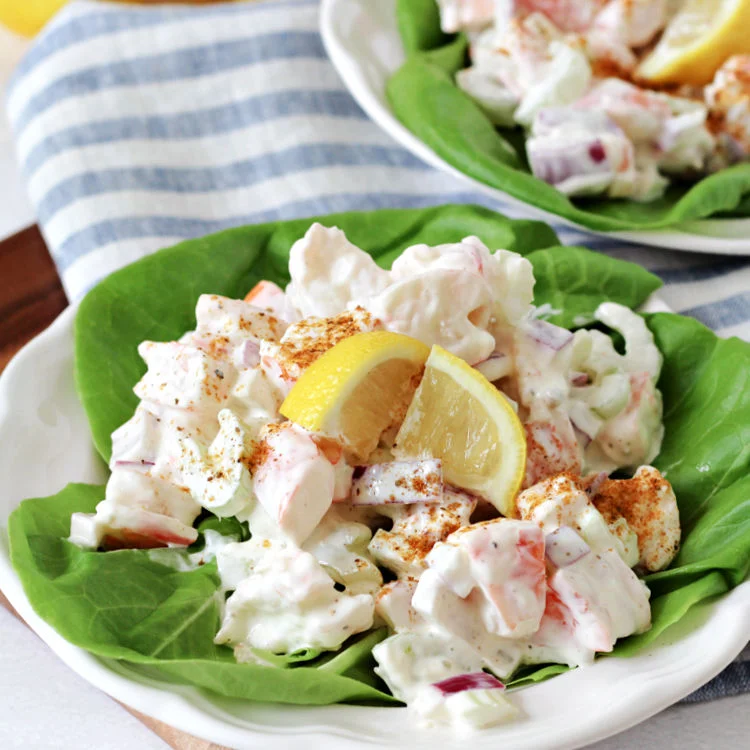 cold shrimp salad on lettuce leaves and plated ready to eat