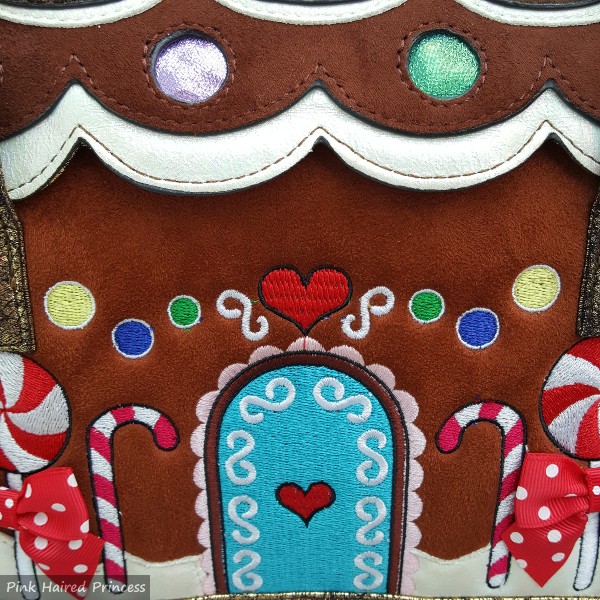 close up of embroidered detail on front of gingerbread house themed bag