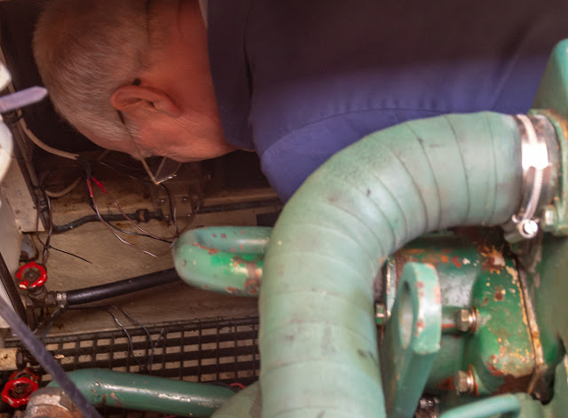 Photo of Phil connecting up the cables to the high water alarm