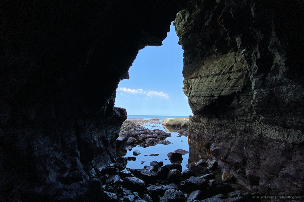 Looking out of the cave towards the blue sky and sea