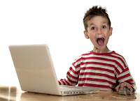 Young boy using a computer and is excited!