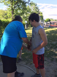 Dr. John McMahon coaching athlete on discus grip