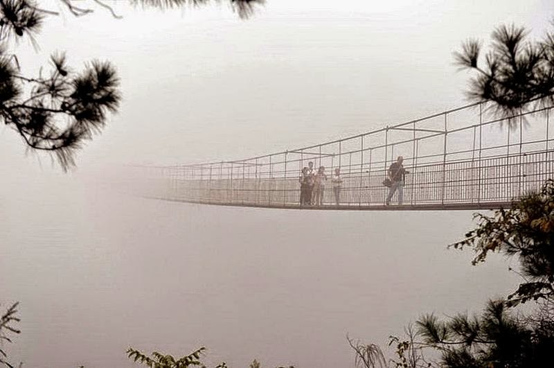 An extraordinary suspension bridge, which is located in in Pingjiang county, in the province of Hunan, southern China, at a height of one hundred and eighty meters. Rocks, between which there is a unique bridge,that straddles two rocky peaks, 300 meters apart. All the tourists passing data structure are in this horror as the blade is fully transparent glass bottom bridge.