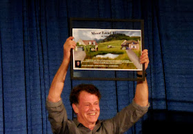 John Noble holds up the prize for the charity auction at Shore Leave 38, Hunt Valley, MD.
