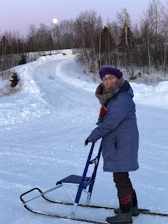 Stainding on Kicksled at Full Moon Rise