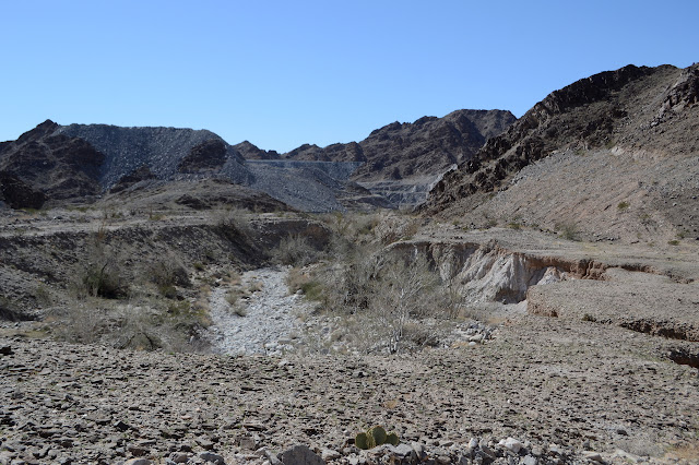 look down the wash to see the open pit