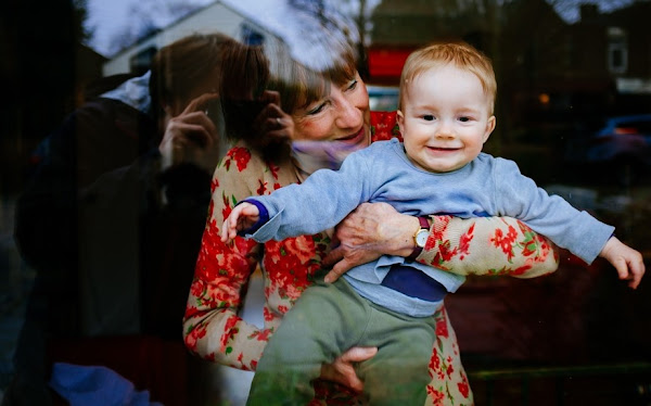 Image: Grandmother and baby boy looking out the window, by Tookapic on Pixabay