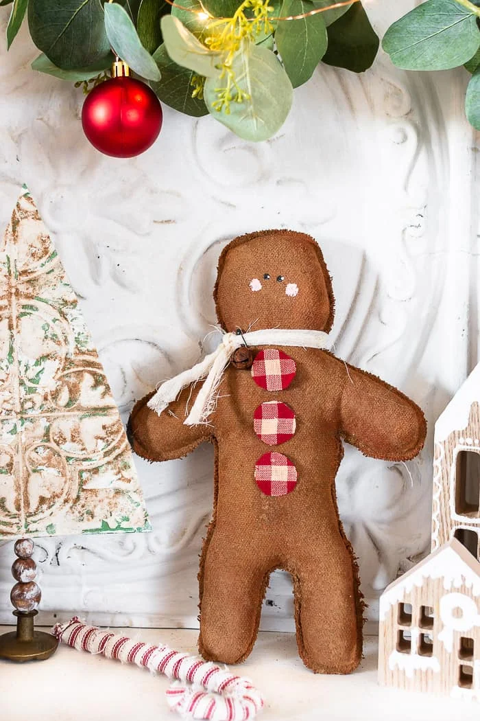 tall gingerbread man, cheesecloth, rusty bell, homespun buttons, painted face