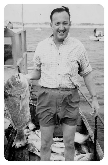 Francis Hodgins kills a fish sometime in the early 1960's.