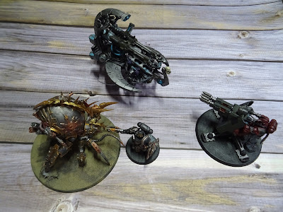 Four plastic painted sci-fi fantasy models on wooden background