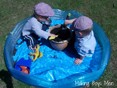 Kids getting their hands dirty digging for treasure with marbles and mud from Making Boys Men