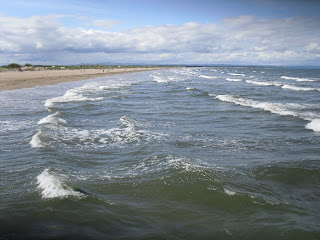 a view across the beach and sea