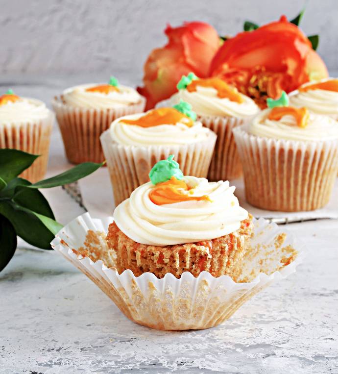 Recipe for moist, carrot cake cupcakes filled and topped with maple cream cheese frosting.