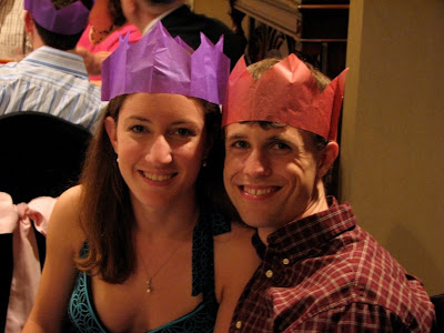 recently wedded couple wearing their crowns as well