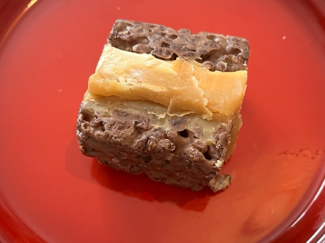 a brown and white food on a red plate