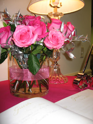 sign in table arrangement med and hot pink roses with birch accents