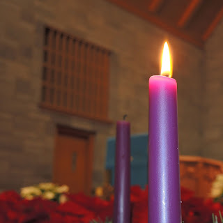 purple Advent candle in church nave