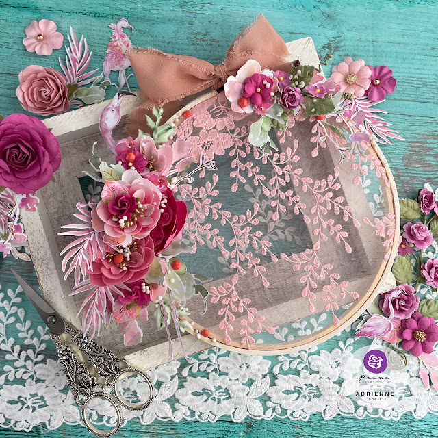 Altered embroidery hoop created with: Prima Marketing. Postcards from Paradise lace, floral ephemera, paper flowers (may flowers, aloha, blissful day), moulds, say it in crystals, Finnabair art stones, impasto paint, Art Philosophy, metallic pastel accents watercolors