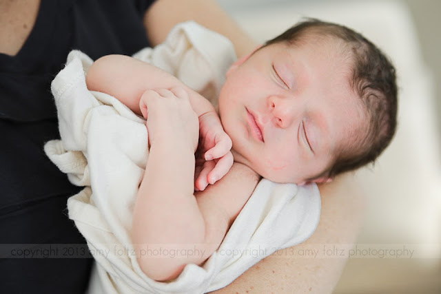 photo of a newborn sleeping in Mommy's arms