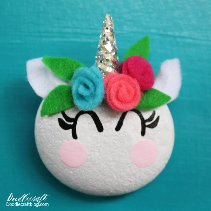 How to paint a unicorn rock with felt flowers, ears and a glittery resin horn.