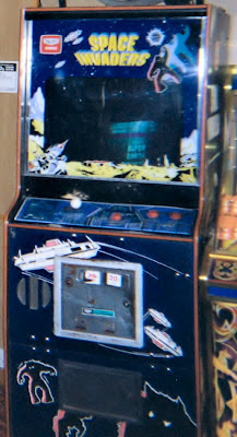 A Japanese Space Invaders arcade cabinet (though the game itself is a 1980 bootleg called Super Earth Invasion) at an amusement arcade in Lyme Regis, Devon. Although there for many years, it was removed at some point between 2007 and 2008. Image taken with disposable camera. by Billy Hicks