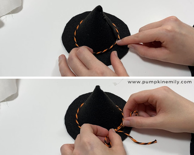 Adding orange and black twine to a witch hat.