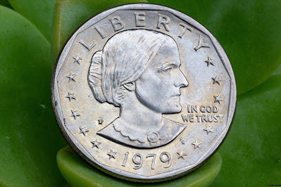 A 1979-P Susan B. Anthony Dollar coin with a portrait of the suffragist Susan B. Anthony facing to the right on the obverse side.