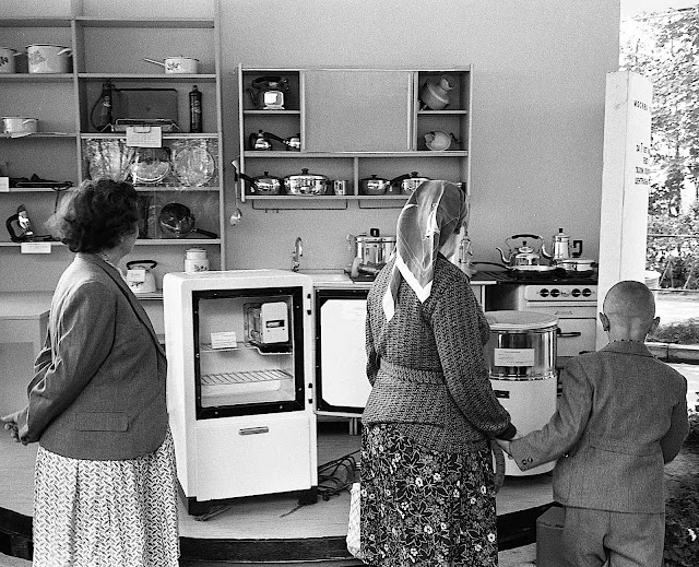 Russian visitors at the 1959 American National Exhibition in Moscow are looking at USA kitchen conveniences