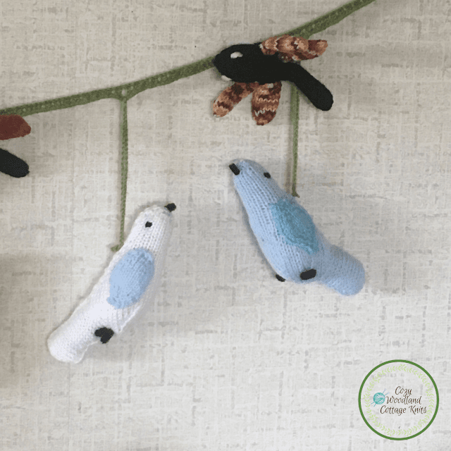 Picture of knitted white and blue spring birds and knitted dragonflies