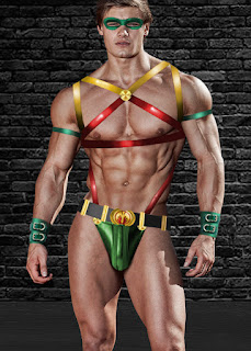 Xaq wears a stylized red-green-yellow spandex and leather costume consisting of straps and a codpiece that reveal his insane body definition.