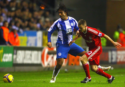 Mido of Wigan Athletic battles with Fabio Aurelio of Liverpool