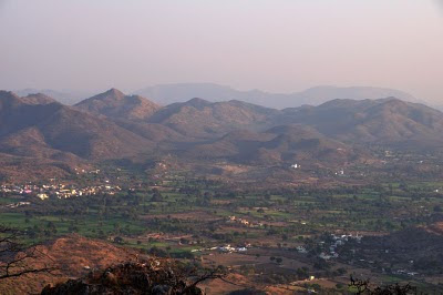 Also named as the Sajjan Garh Palace after Maharana Sajjan Singh, the Monsoon Palace was built on a hilltop to provide a view of the Monsoon clouds. I am not sure how much it is used for that purpose now, but it definitely provides a panoramic view of the Udaipur City. The drive to the palace is pleasant through a wild-life sanctuary, which is a reserve for reptiles, tigers, nilgai, sambhar, wild boars, hyenas, panthers, and jackals. And, as expected, we did not see any of those during the ride. The Monsoon Palace is also the Sunset Point. When we visited, a quite crowd was waiting for the sun to set with their cameras ready on the Tripods. It was a peaceful, safe, and beautiful place, Rajasthan,  Udaipur,  Sunset,  Monsoon, Palace, Monsoon Palace. Aravalli, Hills