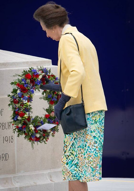 Princess Anne wore a yellow wool jacket and floral print midi dress. The Princess wore a grey trench coat by Musto, and floral dress