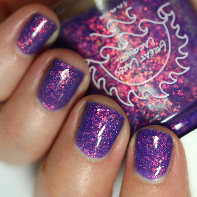 purple nail polish packed with shifty flakes that appear green and orange and gold