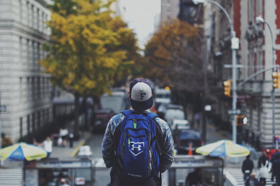 A Person Carrying A Blue Bag In The City Center 