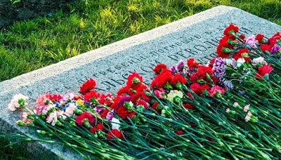 Flowers laying on a soldier's grave.